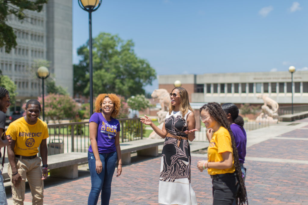 Dr. Artis Laughing with Students on the Library Plaza