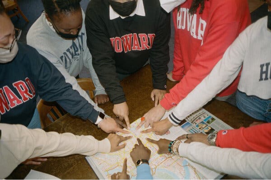 Howard Students pointing to map